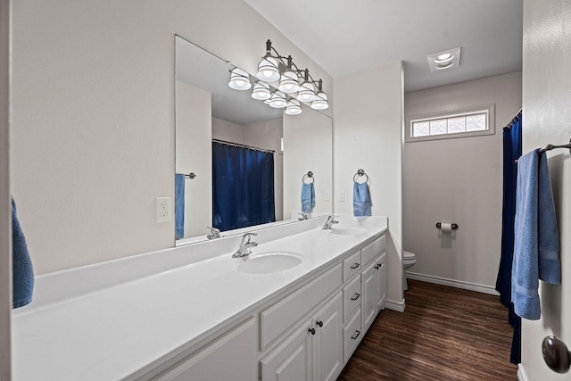 bathroom featuring vanity, toilet, and hardwood / wood-style floors