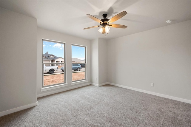 empty room with light colored carpet and ceiling fan