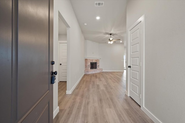 corridor with light hardwood / wood-style flooring