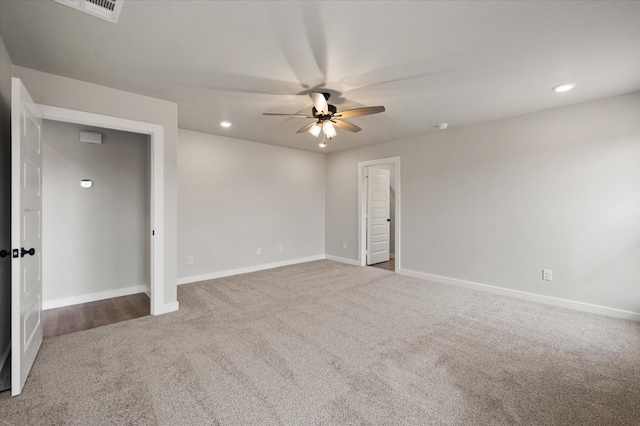 carpeted spare room with ceiling fan