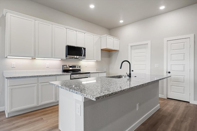 kitchen featuring white cabinetry, sink, an island with sink, and appliances with stainless steel finishes