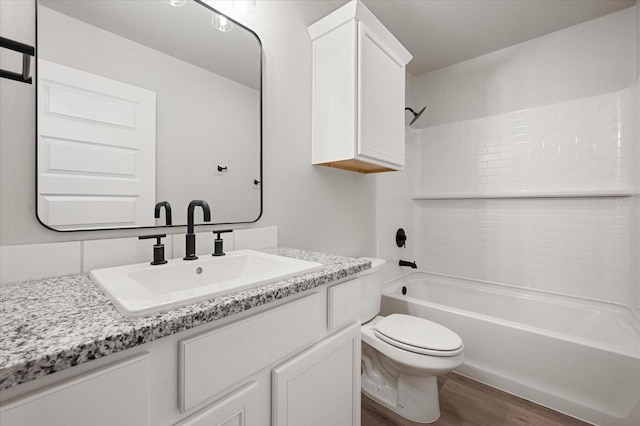 full bathroom featuring vanity, toilet, bathing tub / shower combination, and hardwood / wood-style floors