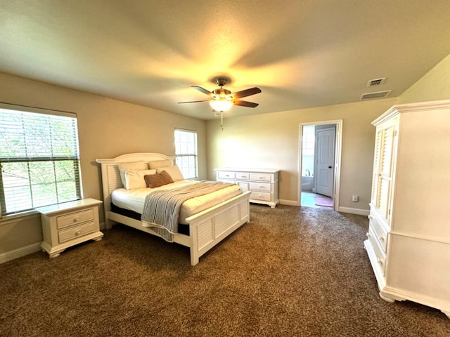 carpeted bedroom with ceiling fan and ensuite bathroom