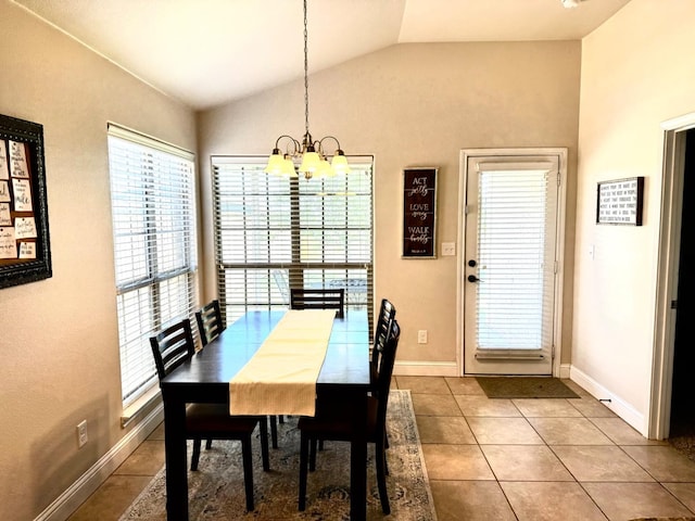 dining room with tile patterned floors, lofted ceiling, and a chandelier