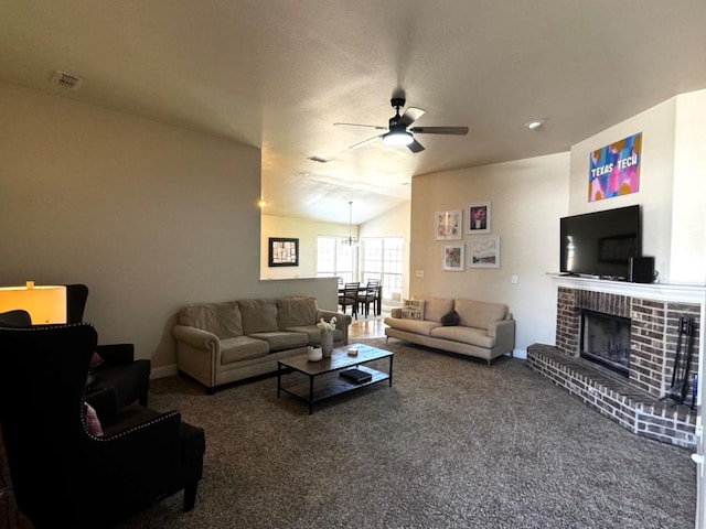 carpeted living room featuring a brick fireplace, vaulted ceiling, and ceiling fan