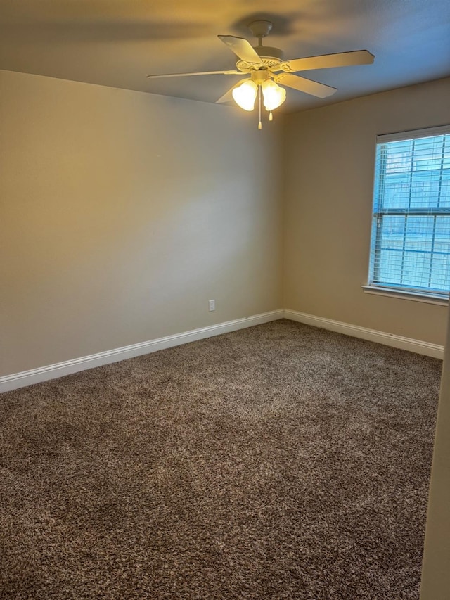 carpeted spare room with ceiling fan