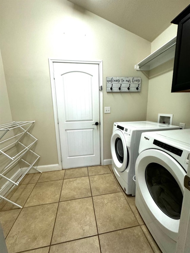 washroom with cabinets, light tile patterned floors, and independent washer and dryer