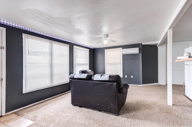 living room featuring a textured ceiling, an AC wall unit, ceiling fan, and carpet flooring