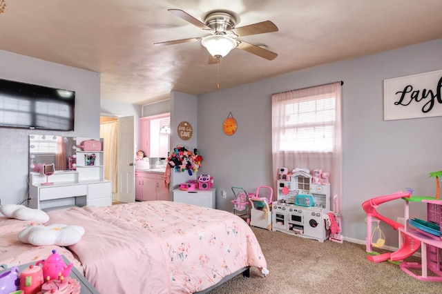 bedroom featuring ceiling fan, connected bathroom, and carpet