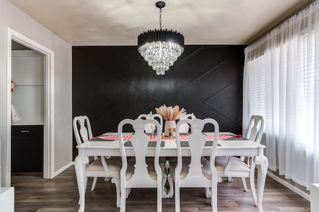 dining room featuring wood-type flooring and a chandelier