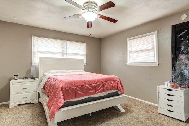 bedroom with multiple windows, light carpet, and ceiling fan