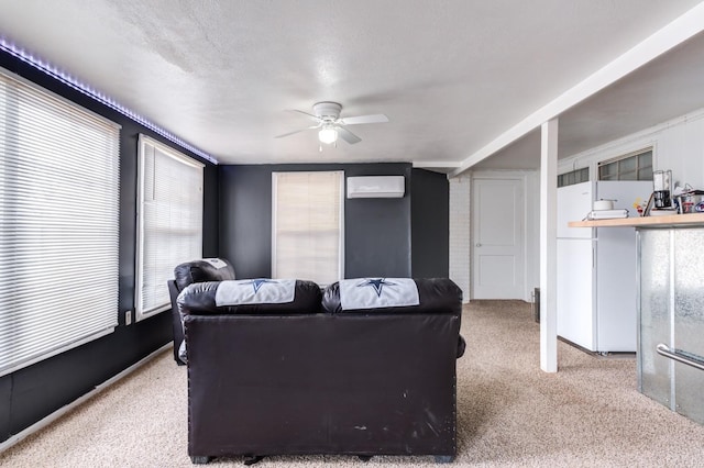 living room with light carpet, a wall mounted air conditioner, a textured ceiling, and ceiling fan