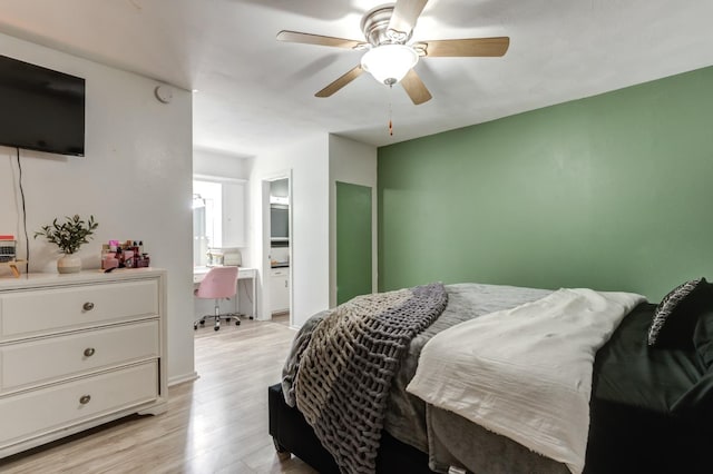 bedroom featuring ensuite bath, light hardwood / wood-style floors, and ceiling fan