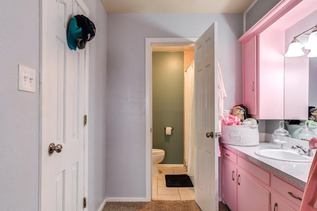 bathroom featuring tile patterned floors, vanity, and toilet