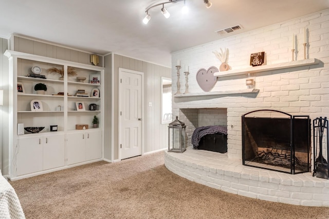 living room featuring a fireplace, light colored carpet, and wooden walls