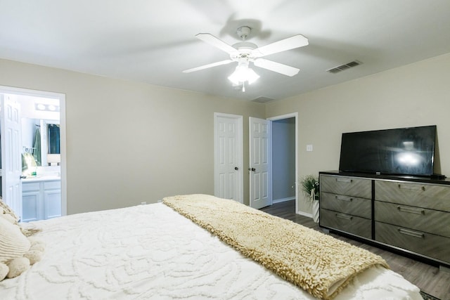 bedroom with ensuite bathroom, ceiling fan, and dark hardwood / wood-style flooring