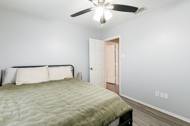 bedroom featuring dark hardwood / wood-style floors and ceiling fan