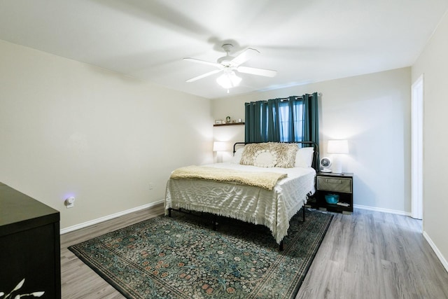 bedroom featuring wood-type flooring and ceiling fan