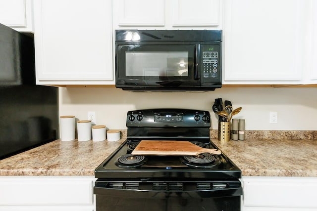 kitchen featuring white cabinetry, light stone counters, and black appliances