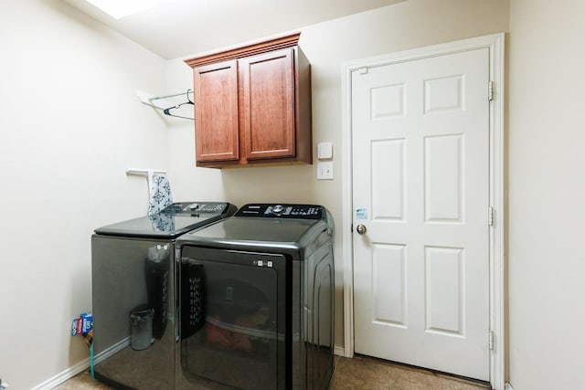 washroom with cabinets and washing machine and dryer