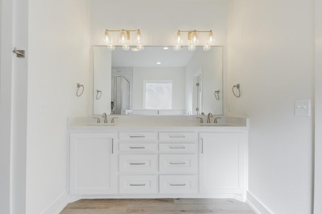 11806 Kenosha Ave, Lubbock, TX 79423 - bathroom with a shower stall, double vanity, and wood finished floors