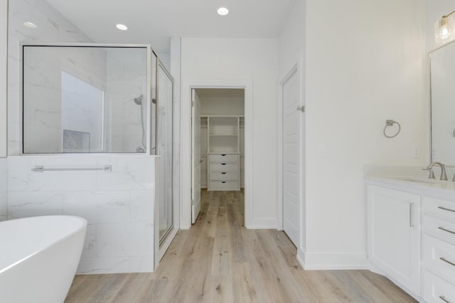 11806 Kenosha Ave, Lubbock, TX 79423 - full bath with a marble finish shower, vanity, a freestanding bath, wood finished floors, and recessed lighting
