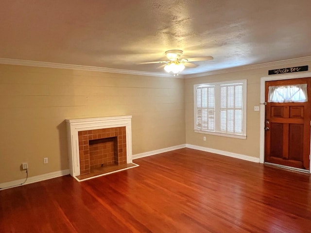 unfurnished living room with hardwood / wood-style flooring, ceiling fan, ornamental molding, and a tiled fireplace