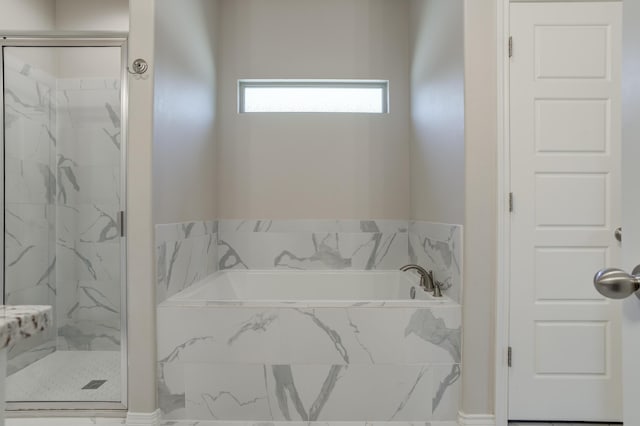 bathroom with a bath and a marble finish shower