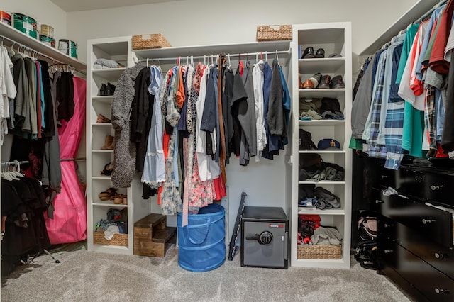 walk in closet with carpet flooring