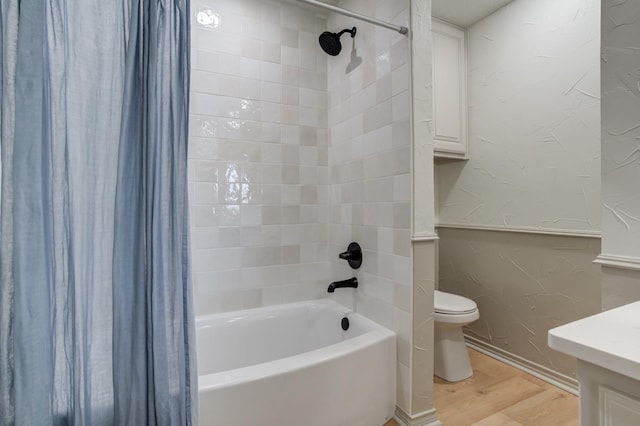 full bathroom featuring hardwood / wood-style flooring, shower / bath combo, vanity, and toilet