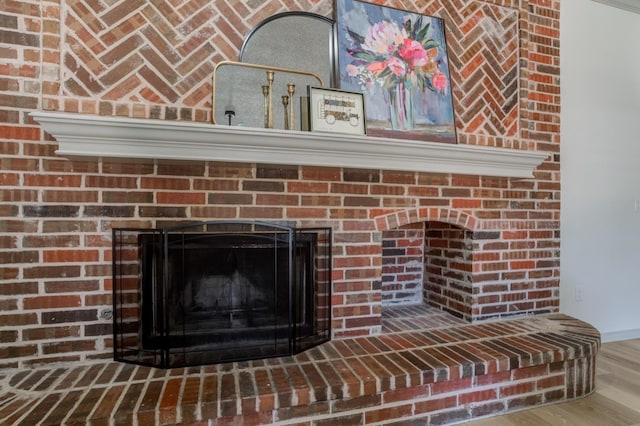 interior details featuring hardwood / wood-style floors and a fireplace