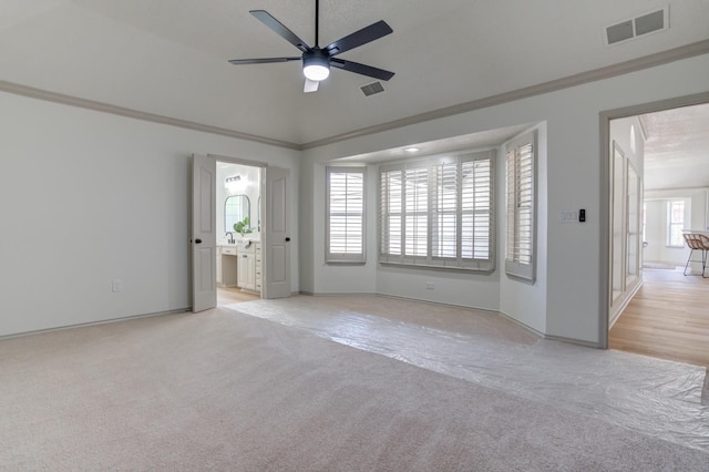 carpeted empty room featuring ornamental molding and ceiling fan