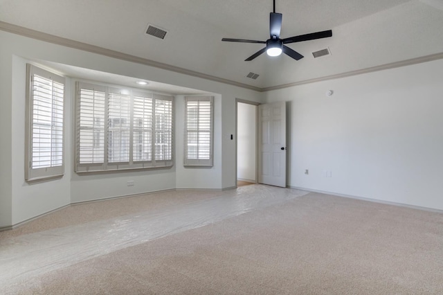 spare room featuring ceiling fan, light colored carpet, and ornamental molding