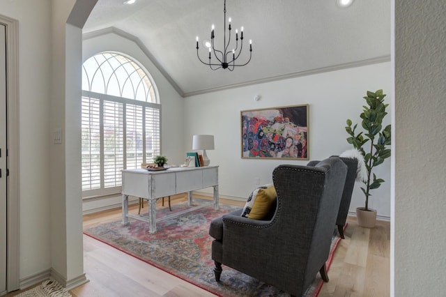 office area with lofted ceiling, ornamental molding, light hardwood / wood-style floors, and a chandelier