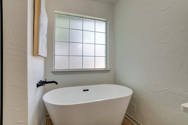 bathroom with a tub to relax in