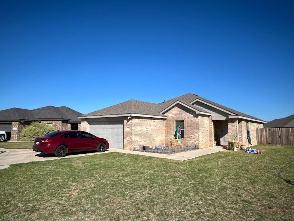 view of front of property with a garage and a front lawn