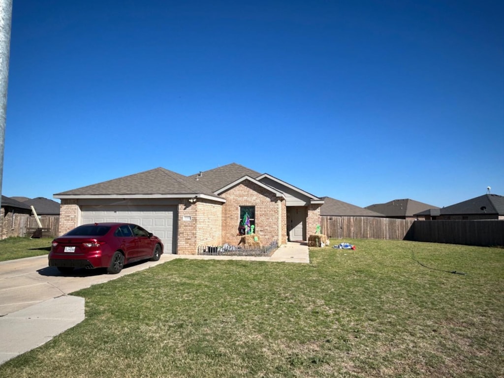 ranch-style house featuring a garage and a front yard