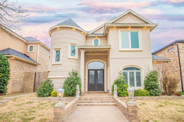 view of front of home featuring french doors and stucco siding