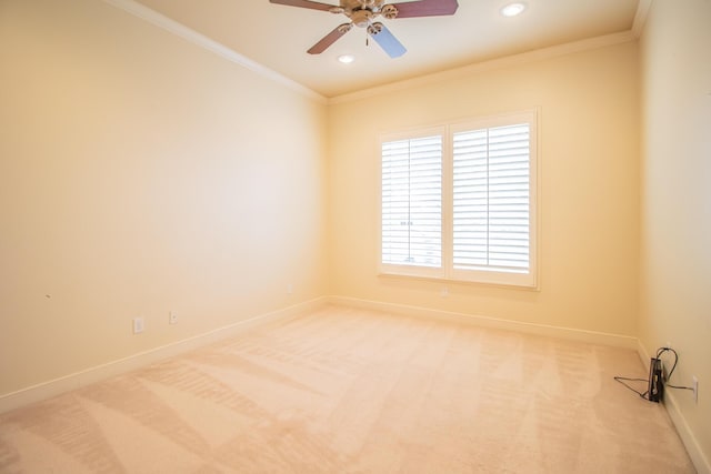 spare room with crown molding, baseboards, recessed lighting, light carpet, and a ceiling fan