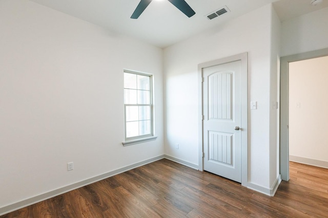 unfurnished bedroom with dark hardwood / wood-style floors and ceiling fan