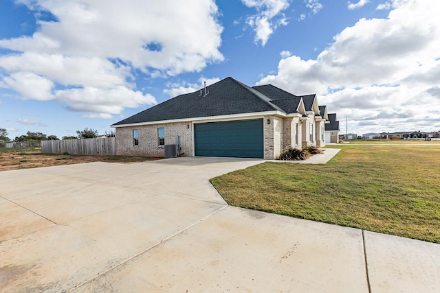 view of home's exterior featuring brick siding, fence, a lawn, driveway, and an attached garage