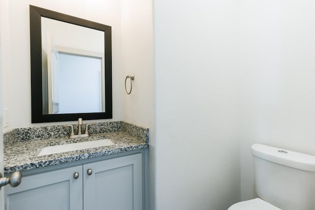 bathroom featuring toilet and vanity