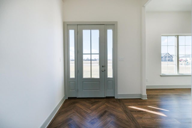 foyer featuring dark parquet flooring