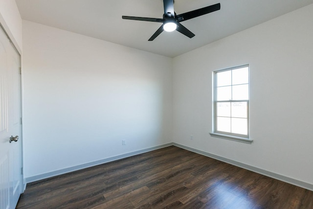 empty room with ceiling fan and dark hardwood / wood-style floors