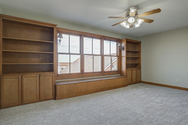 unfurnished living room featuring light colored carpet and ceiling fan