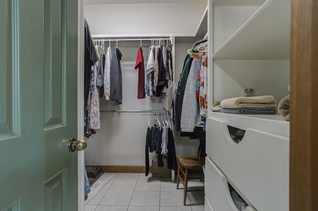 walk in closet with light tile patterned floors