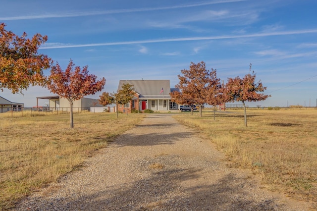 view of front facade with a rural view