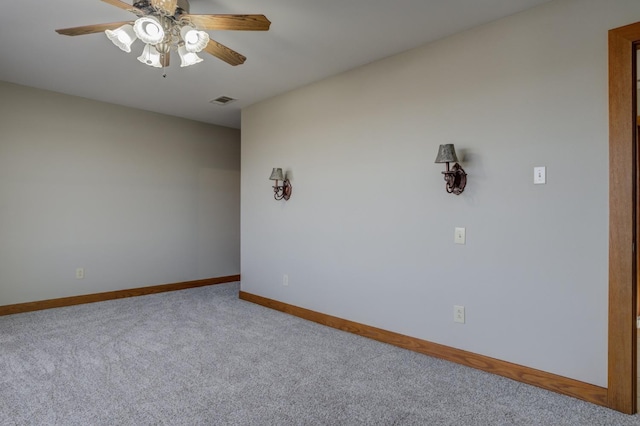 empty room with ceiling fan and carpet flooring