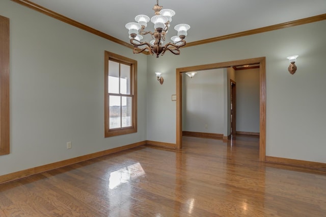 unfurnished room with crown molding, a chandelier, and hardwood / wood-style floors