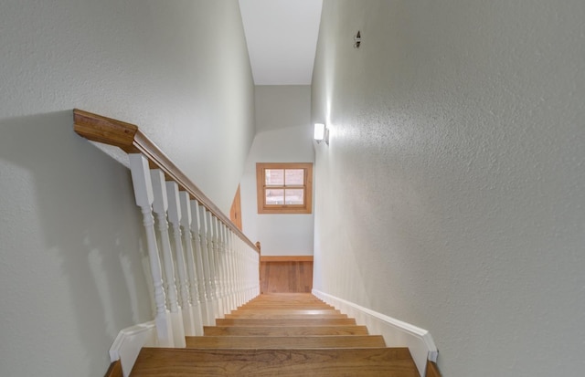 stairs featuring hardwood / wood-style flooring